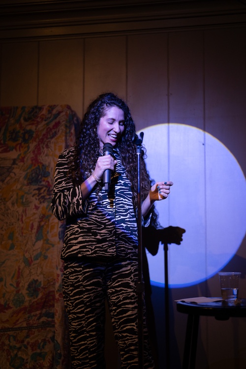 a woman on a stage doing stand-up comedy