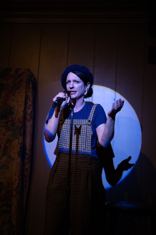 a woman on a stage doing stand-up comedy
