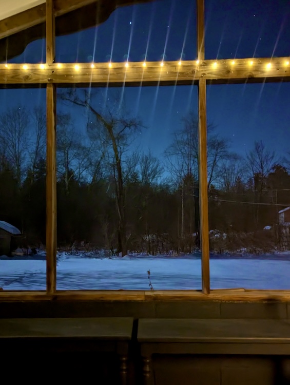 string lights in winter window for warming up a room