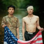borthers holding an American flag by Ocean Vuong