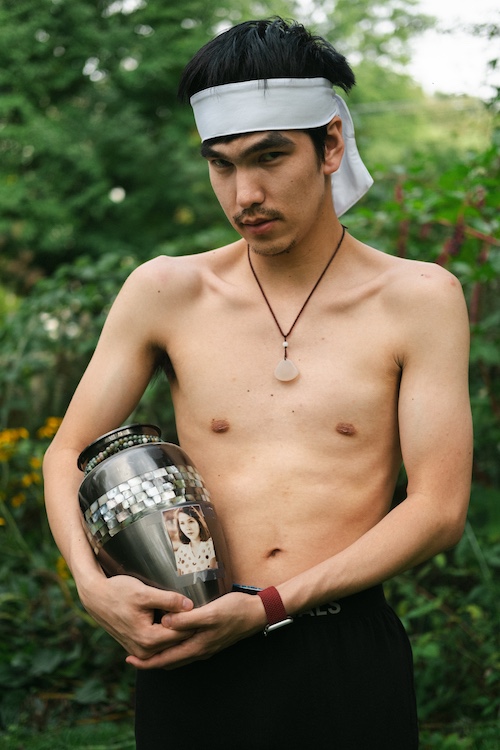 Nicky holding his mother's urn of ashes by Ocean Vuong