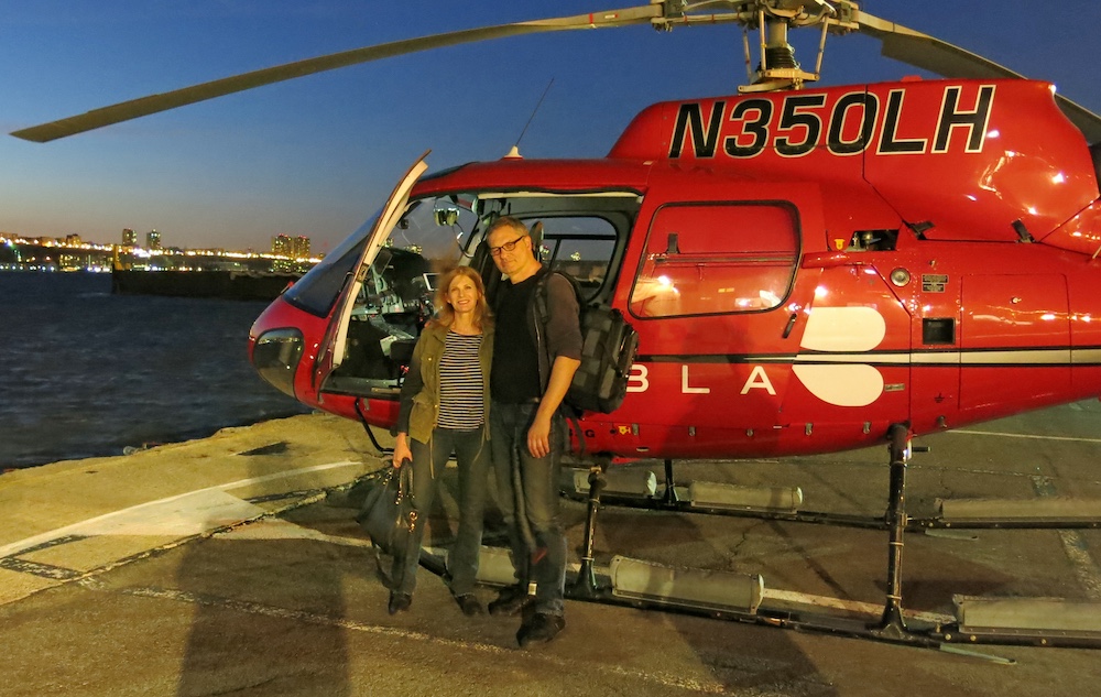 Lauren Bergman and Ed Lederman in front of a red helicopter