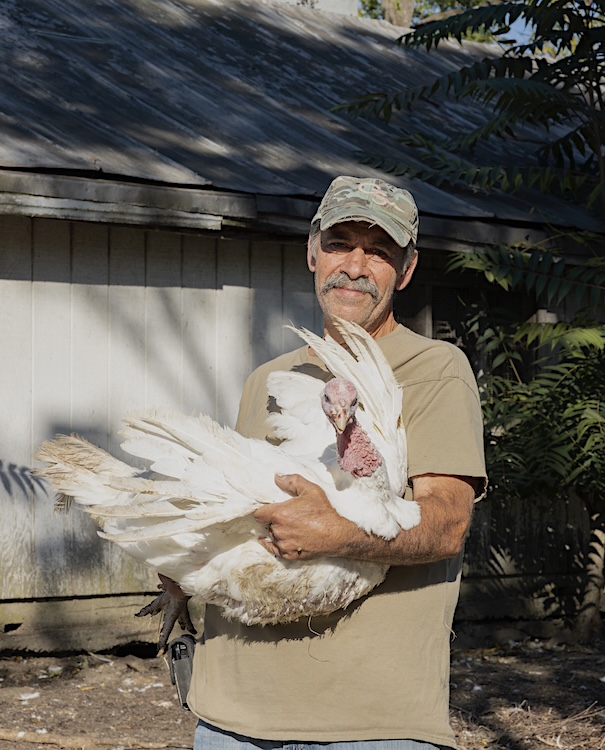 Sal holding turkey on Quattro's Farm