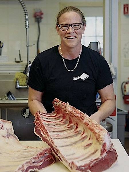 Barb of Barb's Butchery in Beacon NY holding a rack of meats