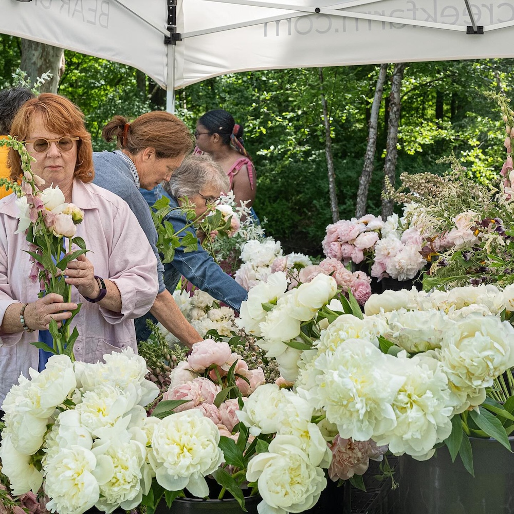 flowers and Bear Creek Farm tent