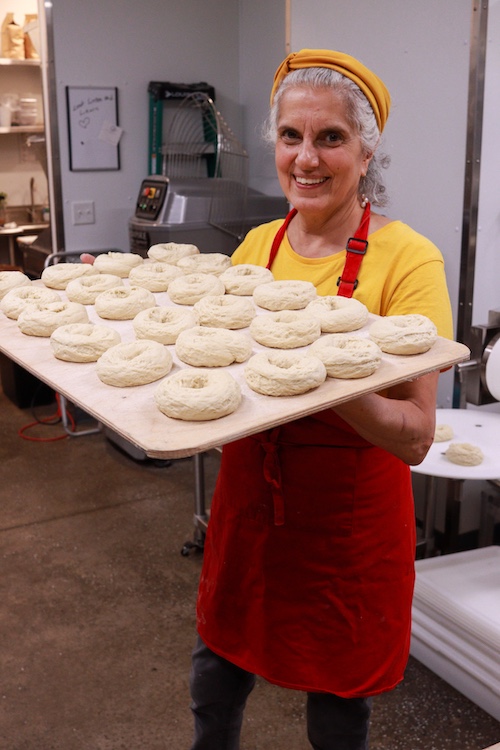 Beth with a tray of raw bagels at Bagel-ish in Beacon NY