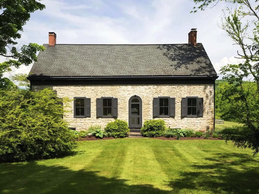 exterior of one of the buildings at the Refined and Elegant Georgian Stone mansion estate in Hurley, Ulster County NY