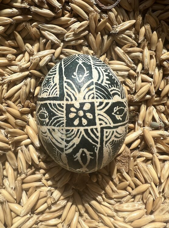 painted egg in green and white with a flower for the Pysanky Workshop for Ukraine by Sasha Botanica