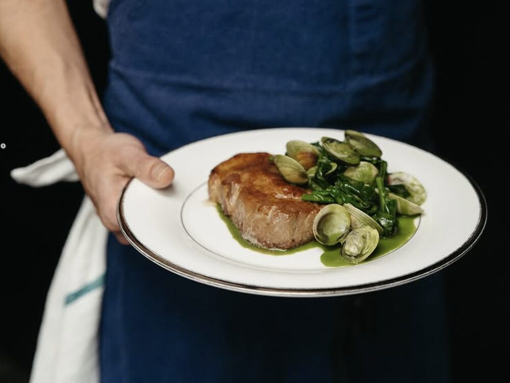food in waitstaff's hand at The Maker in Hudson NY