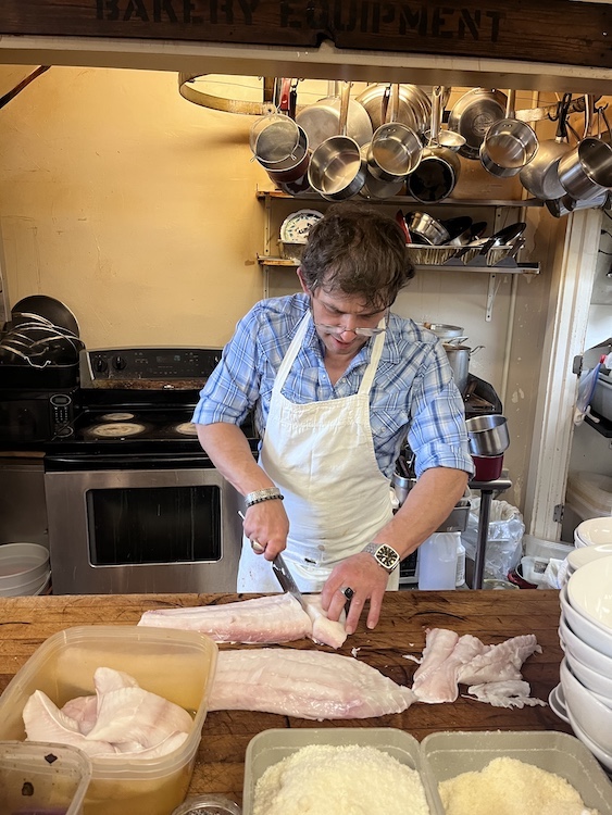 Graziano Tecchio of Graziano’s Downtown Café cutting halibut