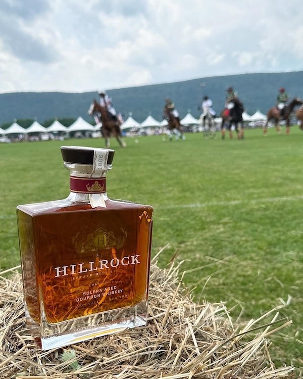 bottle on a hay stack at a polo match by Hillrock Estate Distillery in Ancram NY
