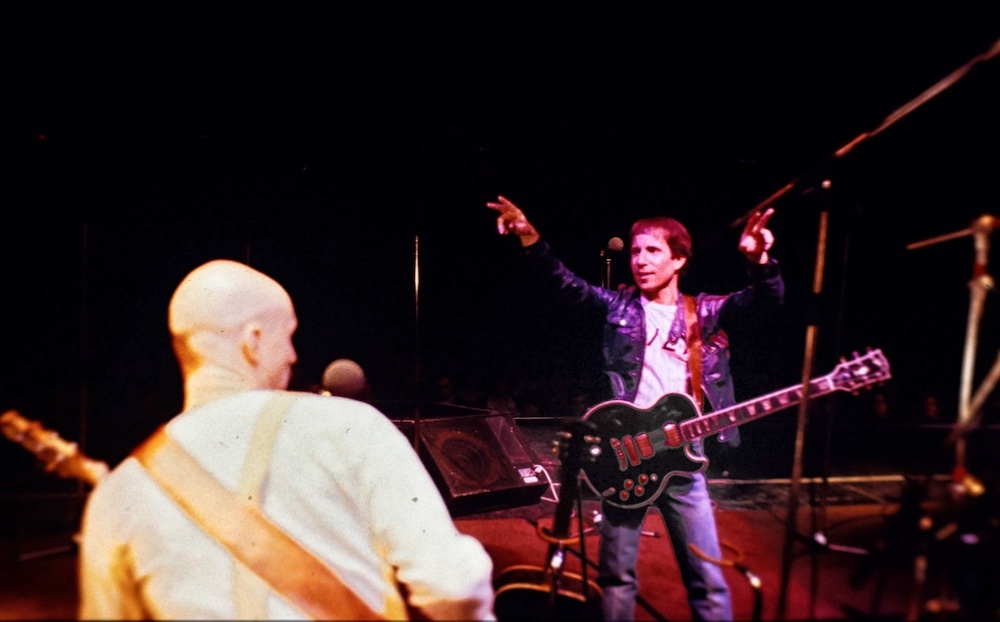 Paul Simon and Tony Levin on stage in 1980