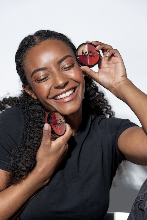 woman with a face wheel makeup tool