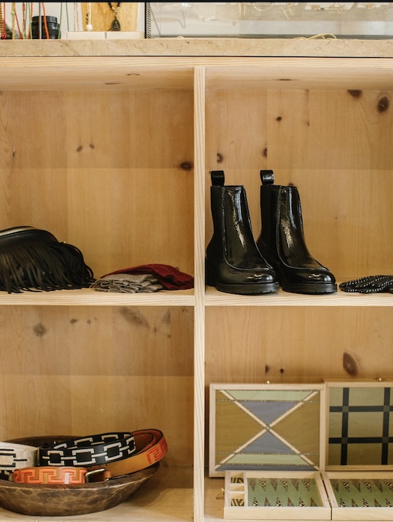shoes and scarves dislayed in wooden boxes