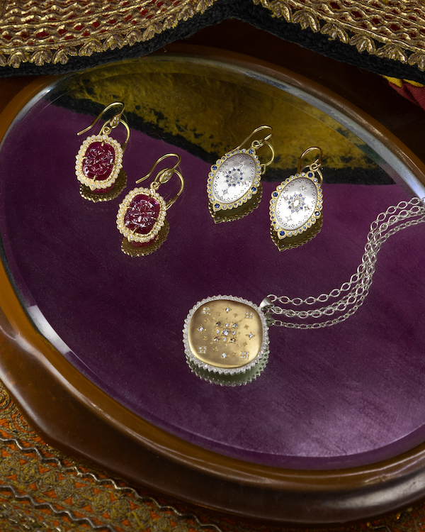 Two pair of earrings and necklace Folded hands with diamond solitaire ring. Adel Chefridi Studio + Gallery in Rhinebeck, NY.