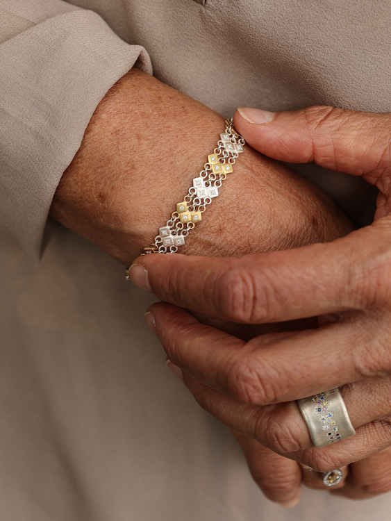 Hand with ring over wrist with bracelet. Folded hands with diamond solitaire ring. Adel Chefridi Studio + Gallery in Rhinebeck, NY.