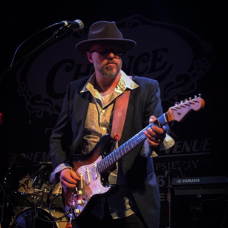 David Chapman playing guitar on stage