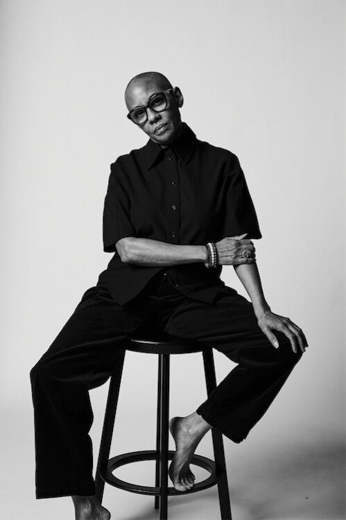 Gail Ann Dorsey on a stool