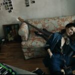 photo of Melissa Auf der Maur next to a couch