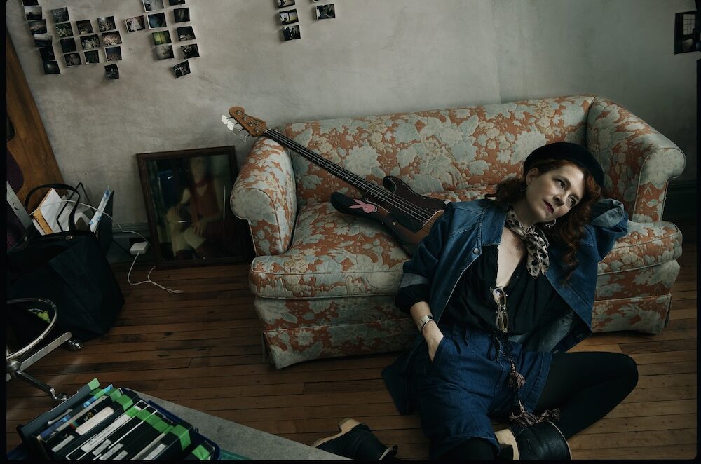 photo of Melissa Auf der Maur next to a couch