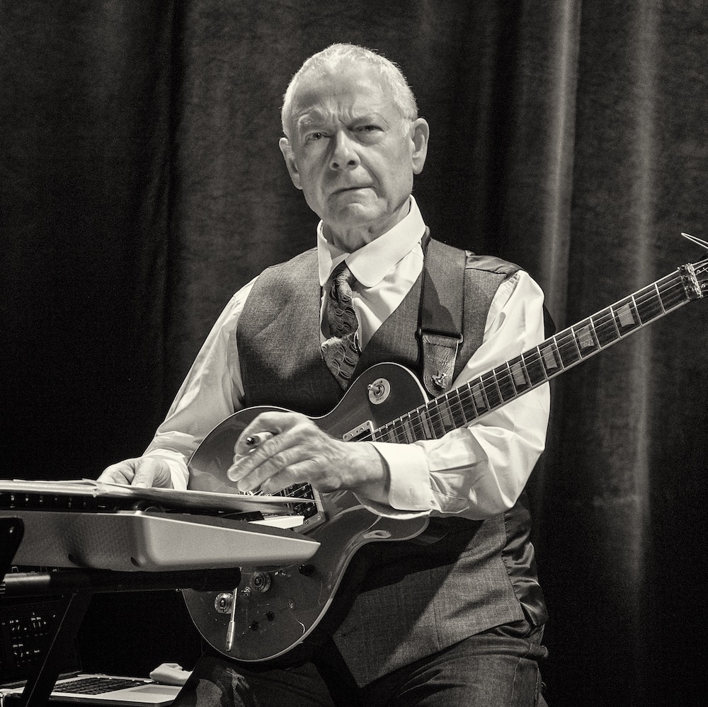 Robert Flipp with guitar on stage
