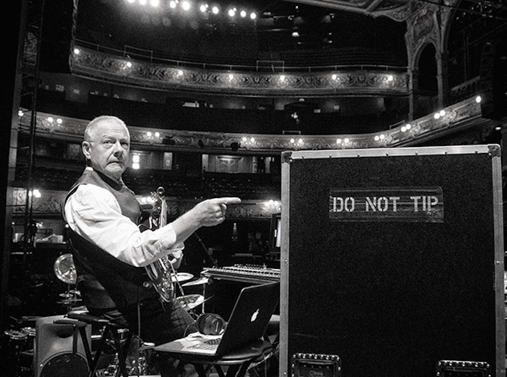 Robert Flipp pointing to a sign on the speaker