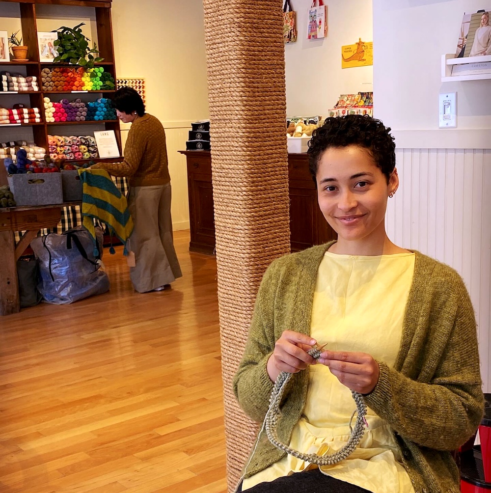 a woman knitting at The Knitting Room