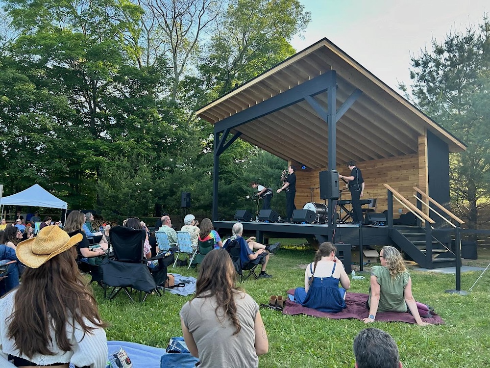 People sitting and watching a concert of live music at the Griffin House.