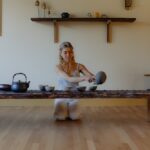 woman pouring tea out of tea pot for a tea ceremony