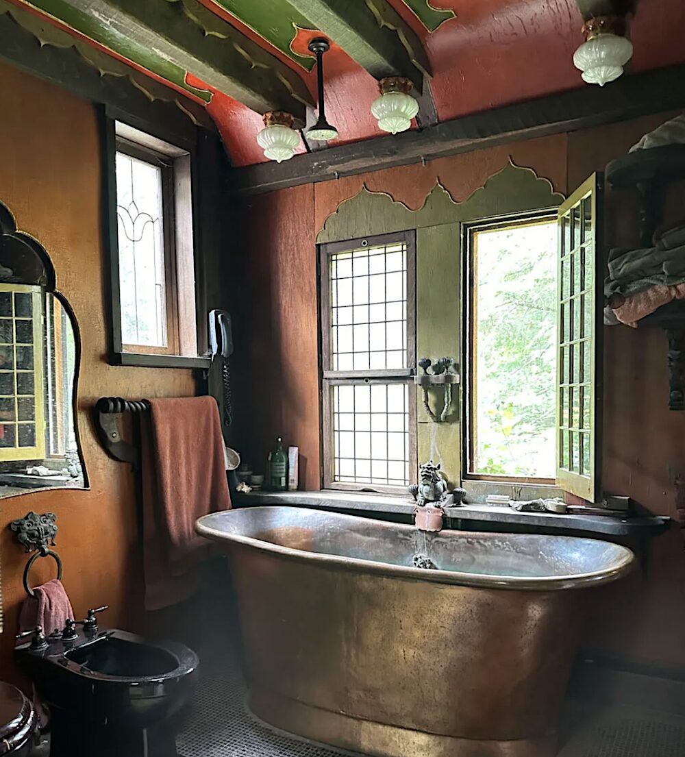 Brass tub next to an open window.