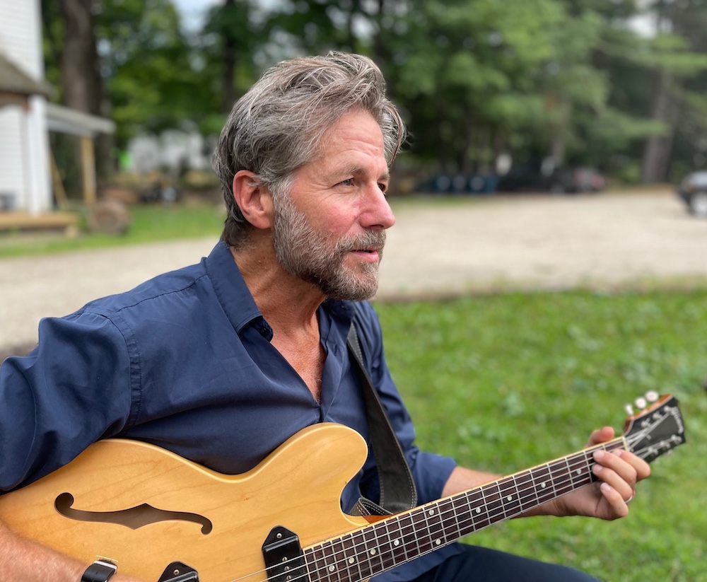 brad cole playing a guitar and thinking