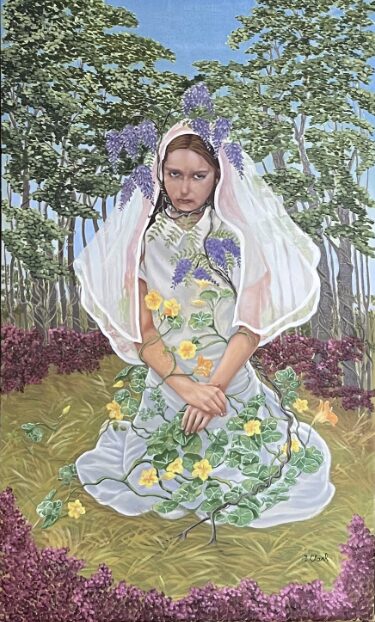 A young woman surrounded by spring flowers in nature dressed in a Communion gown by Emily Clark.