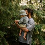 Celebrating Fathers day dad holding a child in the forest