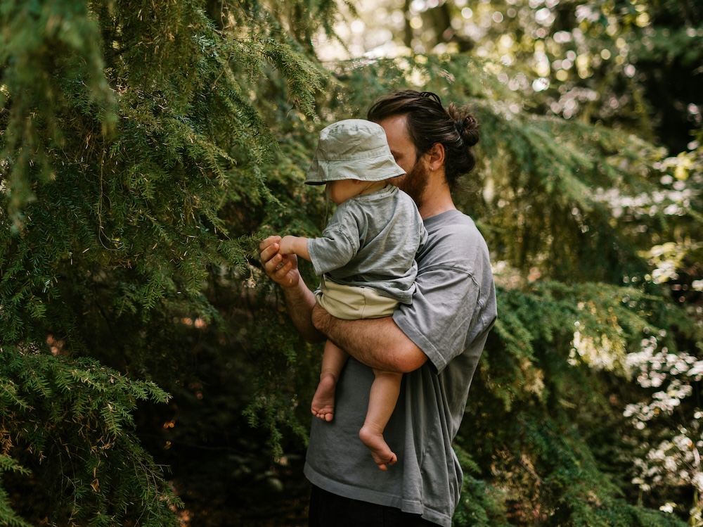 Celebrating Fathers day dad holding a child in the forest