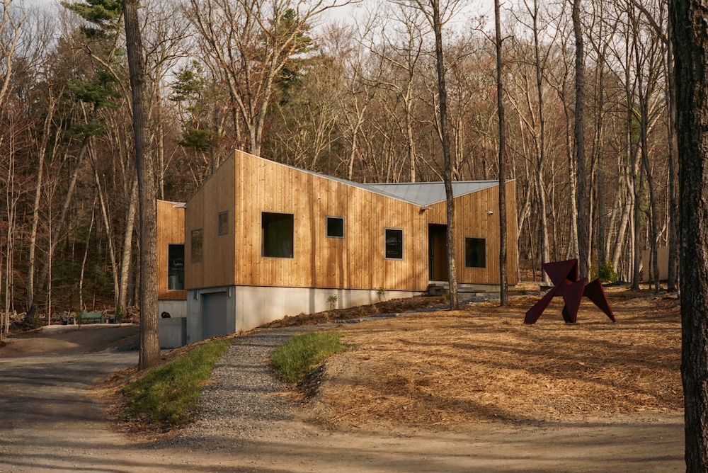 exterior view of the Ohayo Mountain House in Glenford NY between the trees.