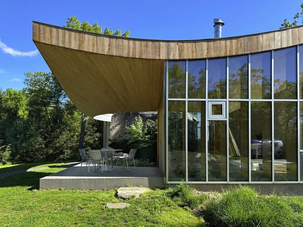 An exterior shot of a side deck and wall of windows.