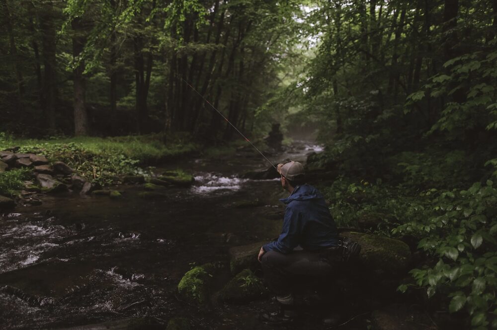 Man fishing in stream upstate NY photo by Peter Crosby