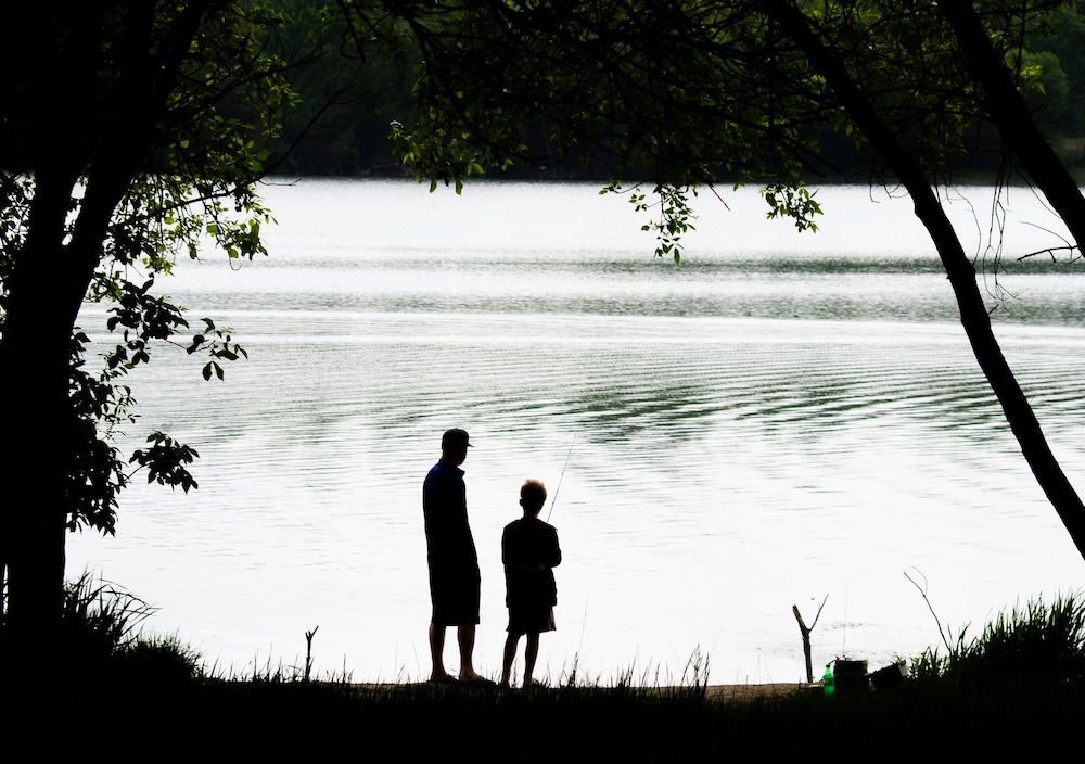 Dad and son on a lake 