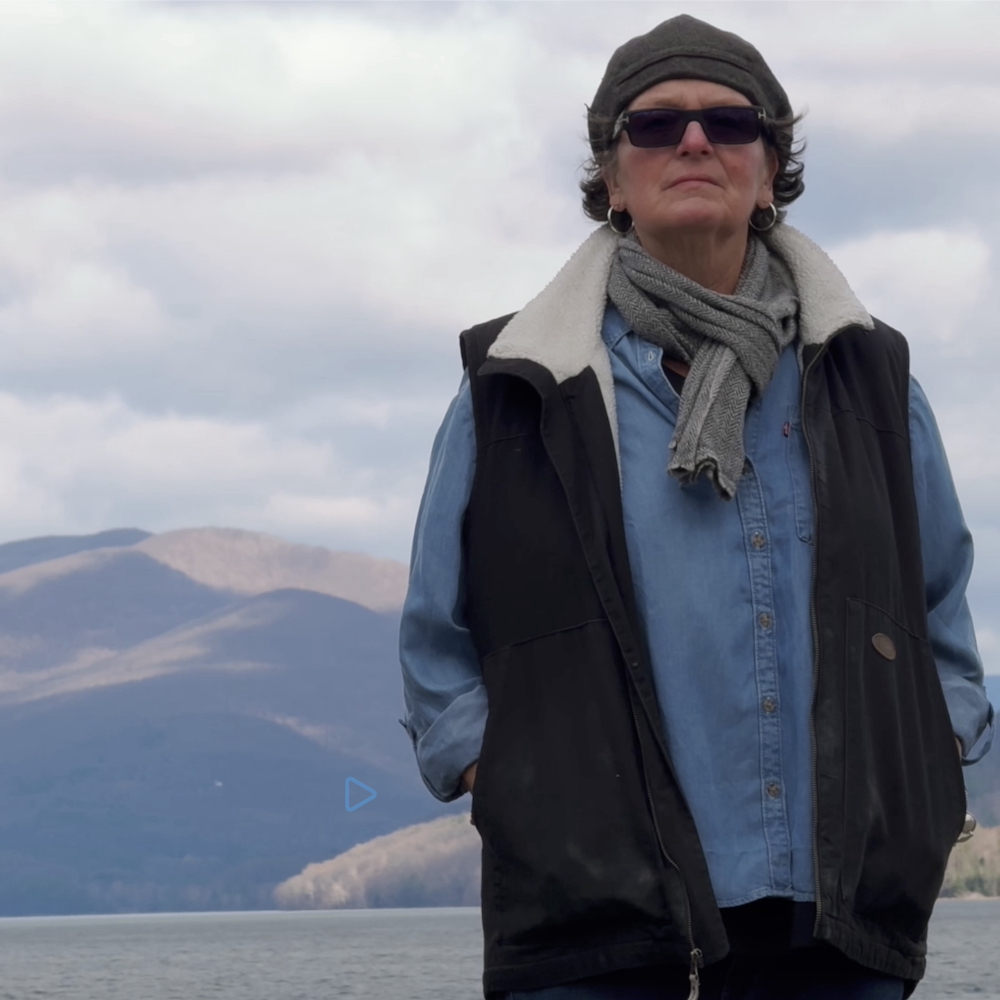 Hudson Valley Painter + Printmaker Kate McGloughlin at the Ashokan Reservoir with Catskill Mountains in background.