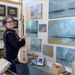 Kate McGloughlin in her studio with her guitar.