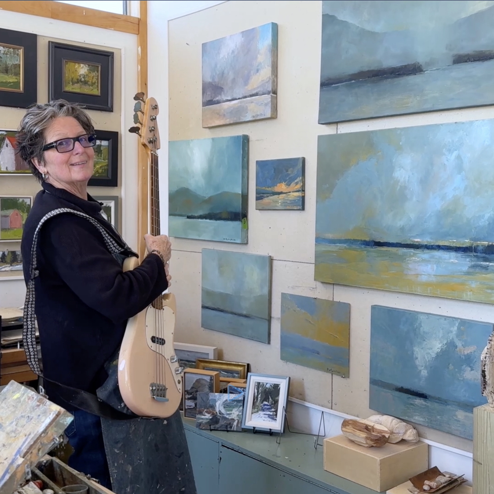 Kate McGloughlin in her studio with her guitar.