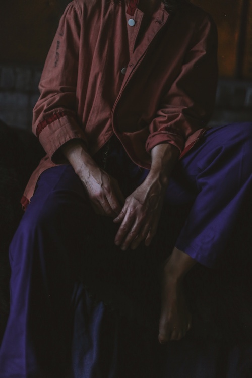 A close up of a person's hands in their lap.
