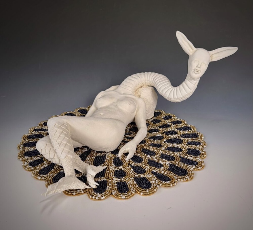 Sculpture of three different species in one laying on a rug looking up by Meredith Morabito