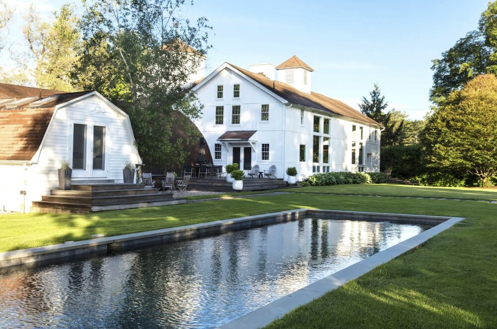 Exterior buildings with a pool in the forefront.