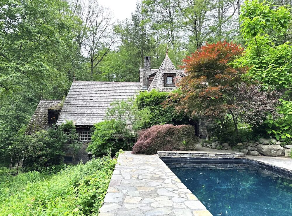 Exterior angle of the house and blue stone pool.