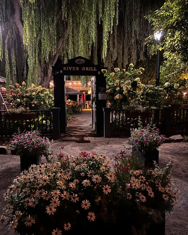 Front door and gardens leading up to the River Grill at Stewart House in Athens NY