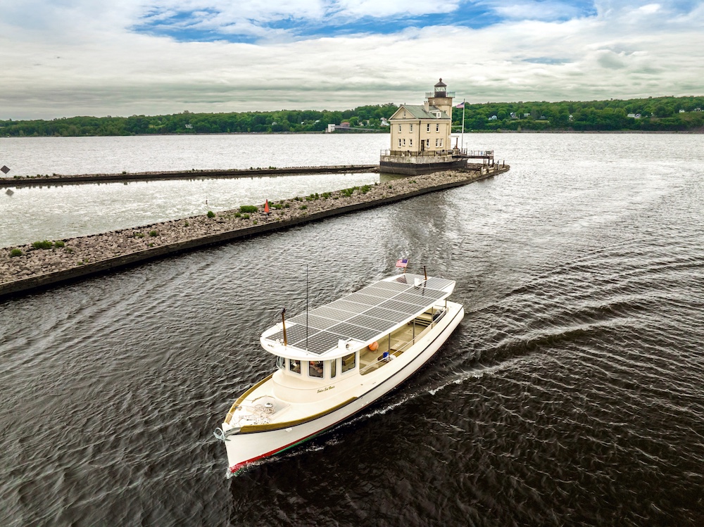 The Solar boat, Solaris, on the Hudson River passing the Kingston NY Lighthouse.