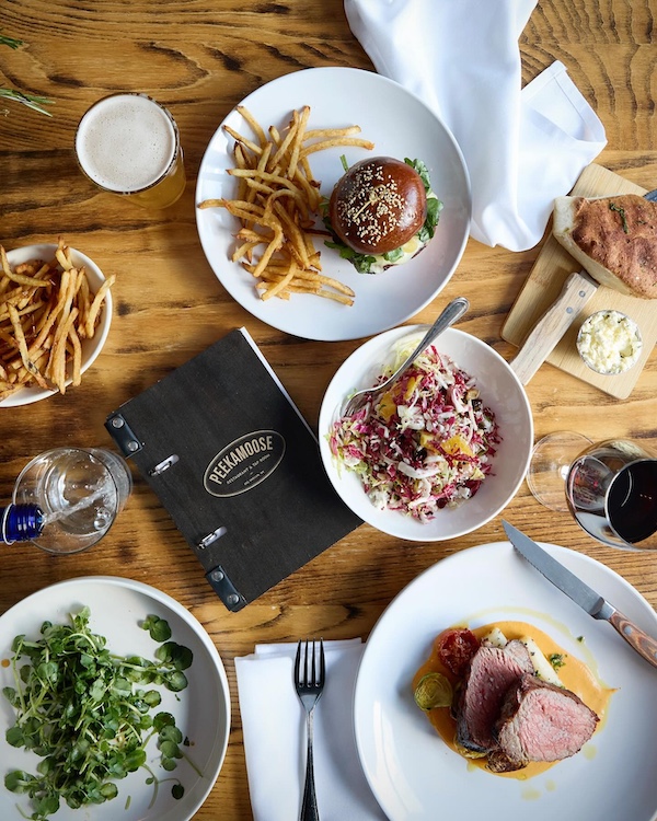 An array of food and menu on a table at Peekamoose Restaurant & Taproom in Big Indian NY