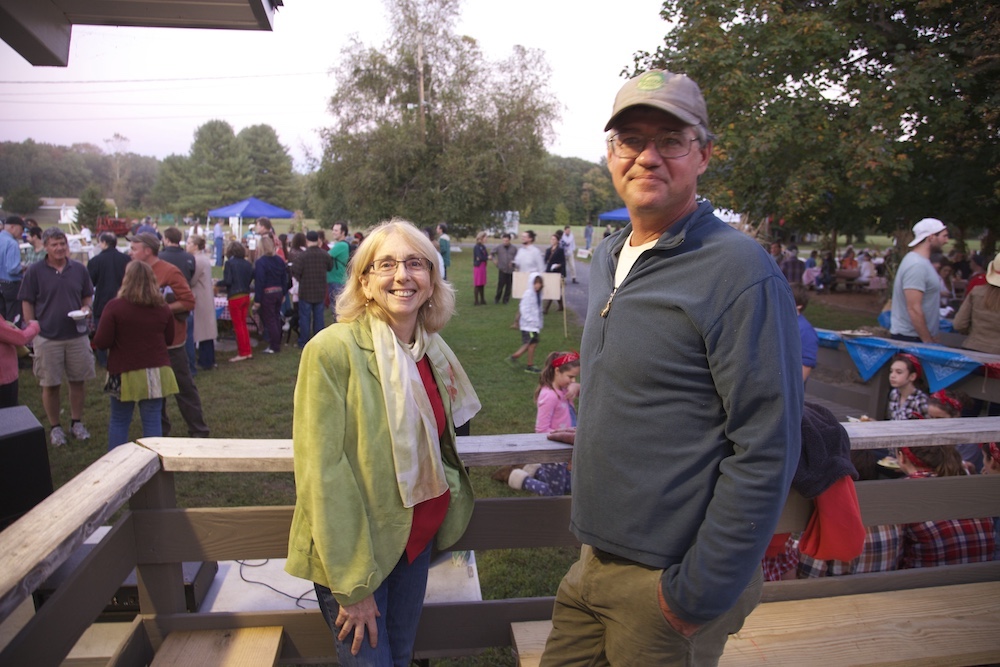 Deborah DeWan and Bruce Davenport talking at a community event.