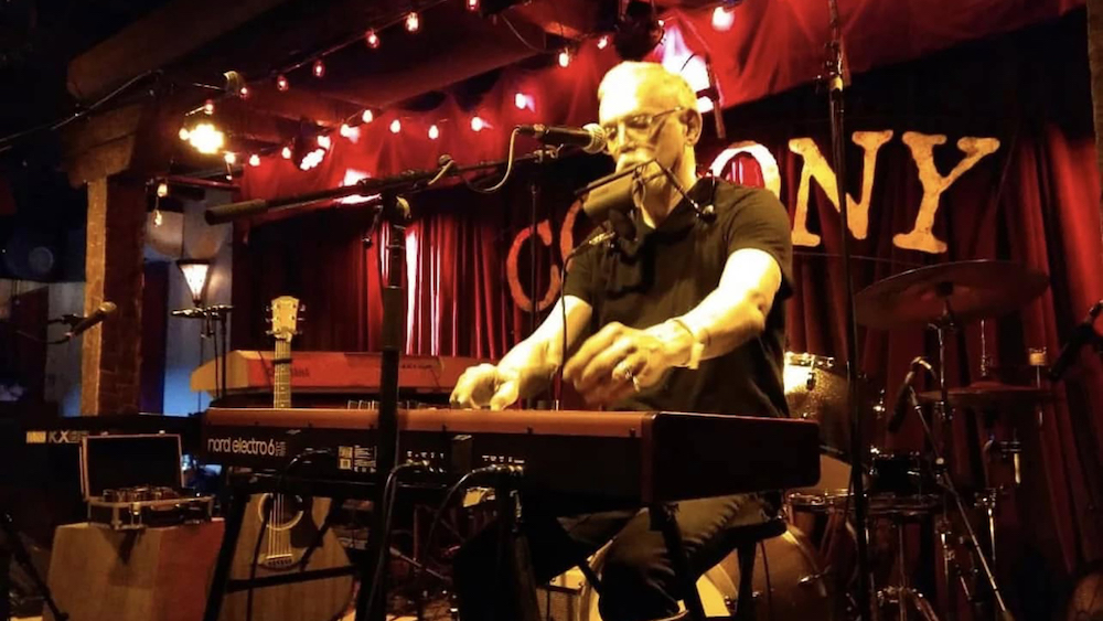 Musician and artist Carl Mateo on stage at The Colony in Woodstock, NY